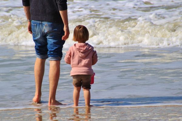 A father and child paddling in the sea