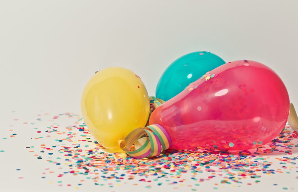 birthday balloons and confetti