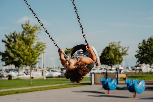 a girl on a swing symbolising how to help your children adjust to life after lockdown
