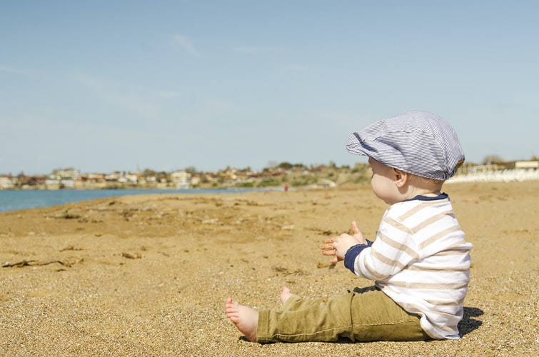 baby on the beach to represent why to take your baby outside